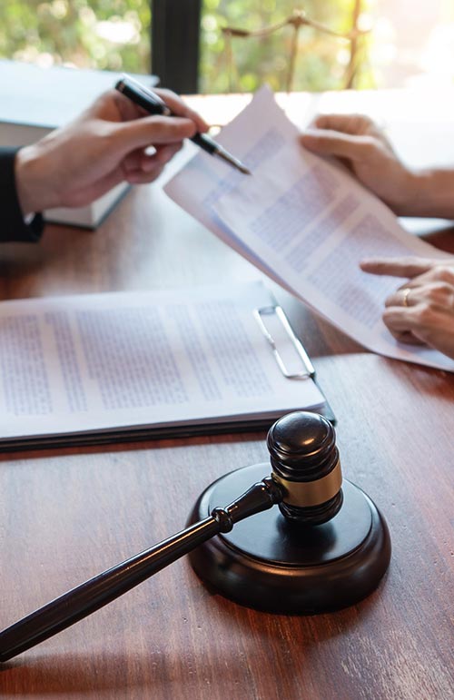 Depositphotos_350750174_L Lawyer working with client discussing contract papers with brass scale about legal legislation in courtroom, consulting to help their customer